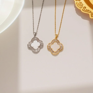 Detailed macro view of gold and silver clover necklaces with inlaid zircon accents
