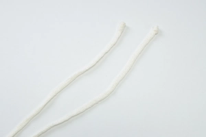 Detail of white woven halter neck straps with knots for a stylish maxi dress