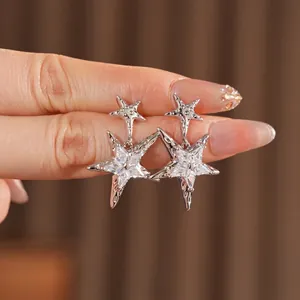 Elegant silver star earrings featuring double-layered pentagrams with zircon stones