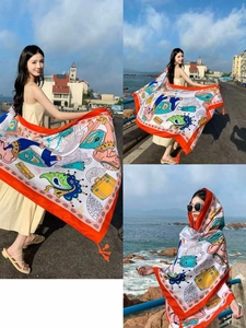 Detail of bohemian sun protection shawl with paisley print and tassels for beach use