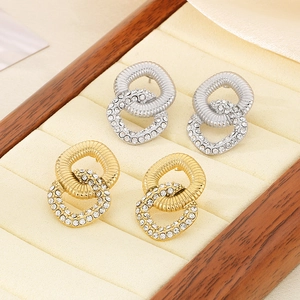 Macro shot of interlocking gold and silver rings with crystals on velvet display