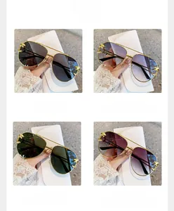 Detailed close-up of golden leopard head emblem on aviator sunglasses metal temples