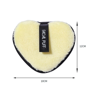 Reusable heart-shaped microfiber facial puff in yellow with 12x10cm size markers