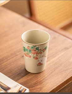 Detail of Ruyao celadon tea cup with strawberry rabbit motifs and ice crackle glaze
