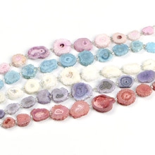 Macro view of natural druzy agate slice beads in pink blue and purple colors