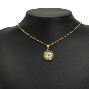 Golden necklace featuring a daisy pendant with colorful rhinestones on a black bust model