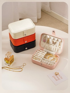Portable PU leather travel jewelry box with multi-layer storage for rings and necklaces.