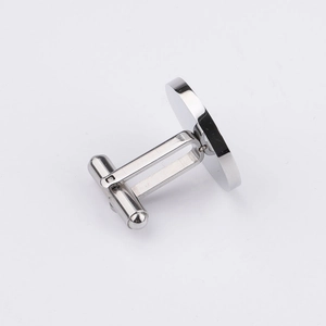 Detailed side view of a polished silver stainless steel bullet back cufflink