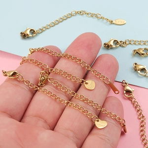 Golden stainless steel chain extenders with lobster clasps and diverse charm shapes