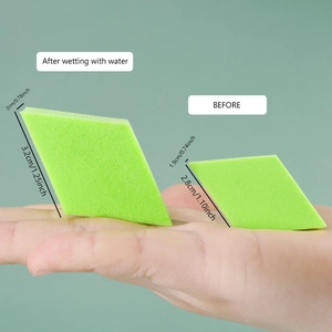 Non-latex diamond makeup sponge showing size expansion after wetting in grass green