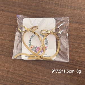 Sweet 18K gold-plated stainless steel bow earrings with long snake chain tassel pendants