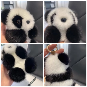 Detail views of a plush panda keychain with soft faux fur and gold metal ring