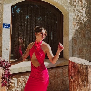 Close-up of bright pink halter dress featuring 3D flower detail and cutout design