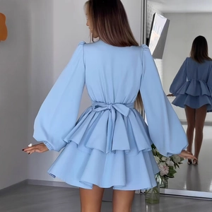 Detail of light blue mini dress featuring layered ruffles and back waist tie design