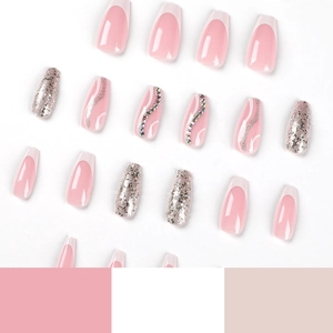 French tip press-on nails with silver glitter and rhinestone accents on white background