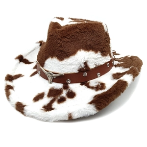Detail of the cow print texture and silver bull head emblem on the western cowboy hat