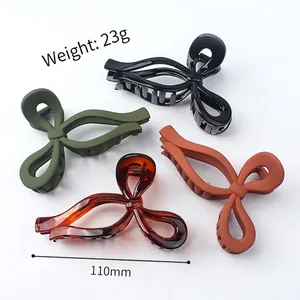 Minimalist large bow hair claw clips in black, olive green, brick red and tortoise pattern