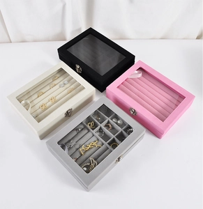 Detail view of colorful jewelry boxes with clear glass lids and metal buckles