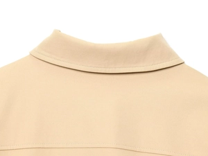 Close-up of khaki shoulder padded jacket collar showing sharp twill fabric texture