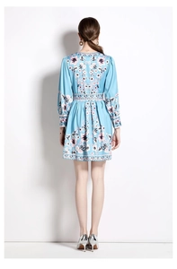 Detail shot of the back view of a light blue floral mini dress with elastic waist