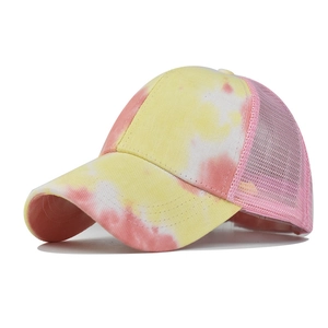 Detail of pink tie-dye pattern and breathable mesh back on the sun visor baseball cap