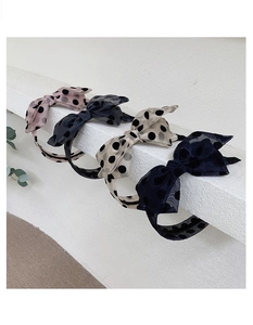 Close-up of elegant polka dot tulle headbands in pink, black, beige and navy colors