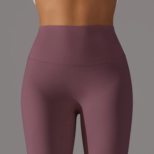Close-up of wide high-waist band on matte yoga leggings showing tummy control effect