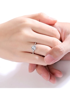 Close-up of a s925 silver moissanite engagement ring with classic six-prong setting