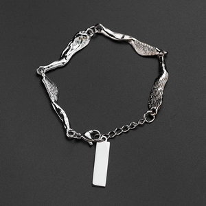 Minimalist silver irregular chain bracelet with blank rectangular tag on grey surface