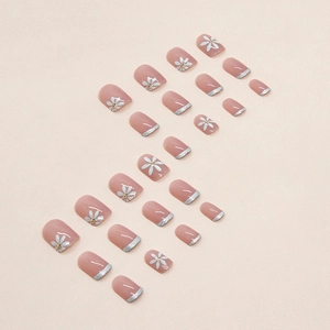 Short nude pink press-on nails with white daisy art and silver glitter French tips