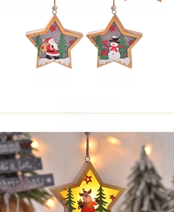 Detail of wooden star-shaped Christmas LED ornament featuring Santa and warm glowing light