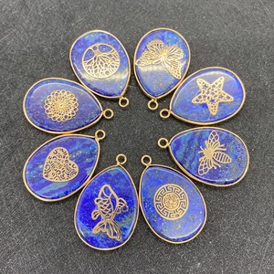 Natural lapis lazuli teardrop pendants with gold filigree patterns in circular layout
