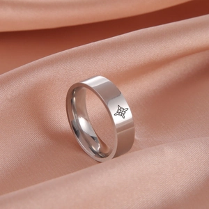 Polished titanium steel ring with Celtic witch knot symbol on pink silk background