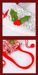 Detailed close-up of knitted and plush Christmas gift bags with red drawstring and holly leaf