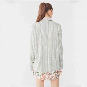 Back view of a casual plaid blazer for women featuring a minimalist mint green check pattern
