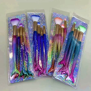 Detail of four sets of mermaid tail makeup brushes with gradient electroplated handles