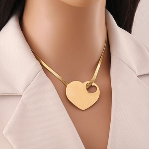 Golden heart snake chain necklace with hollow heart detail worn by a model