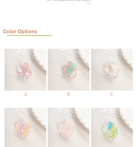 Detail showing various marbled acrylic hair claw clips in assorted pastel ink patterns