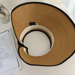 Detail of breathable straw sun hat showing interior sweatband and weave texture