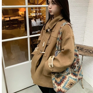 Detail of vintage checkered plush tote bag with ethnic pattern texture on a camel coat