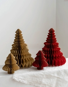 Close-up of paper honeycomb Christmas trees in dark red and brown with golden hanging loops
