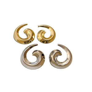 Polished gold and silver spiral metal stud earrings with a minimalist snail design