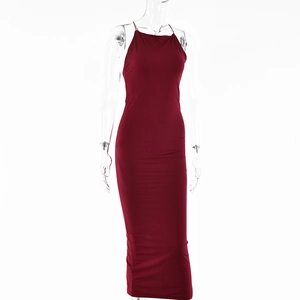 Detail of the high-slit hem and backless cut on a deep red bodycon midi dress