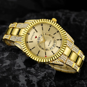 Detailed macro view of a gold men's quartz watch with rhinestones on dark rock