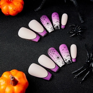 Matte purple Halloween press-on nails with spider web and bat designs in coffin shape