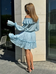 Detail of light blue off-shoulder satin dress with layered ruffles and flared sleeves