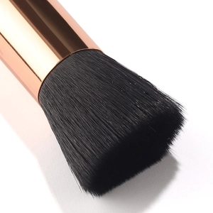 Professional flat top foundation brush with dense black bristles and rose gold ferrule