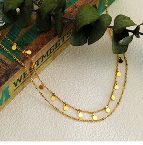 Detail of 18K gold-plated double-layer necklace with speckled circular discs