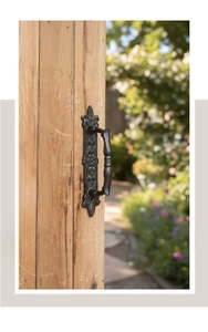 Close-up of European retro cast iron gate pull handle with ornate floral carving details