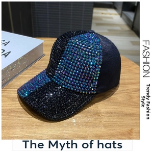 Detailed view of luxury baseball cap with gradient rhinestones on a wooden desk